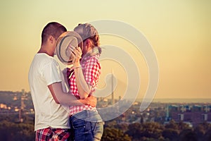 Shy kiss behind hat on first date