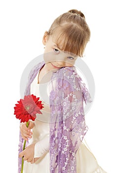 Shy little girl in dress holding red flower