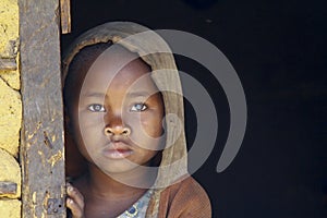 Shy and poor african girl with headkerchief photo