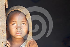 Shy and poor african girl with headkerchief photo