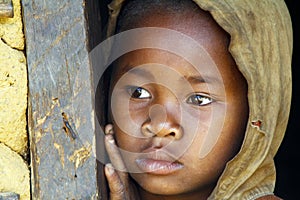 Shy and poor african girl with headkerchief photo