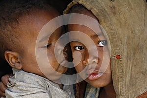 Shy and poor african girl with headkerchief photo