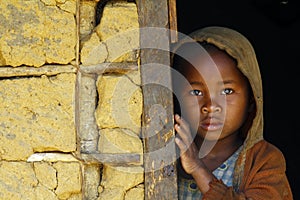 Shy and poor african girl with headkerchief photo