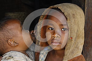 Shy and poor african girl with headkerchief photo