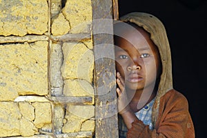 Shy and poor african girl with headkerchief photo