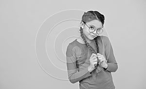 She is shy. Positive emotions. kid wear glasses because of poor eyesight. Portrait of happy girl in glasses. beautiful