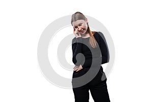 Shy pre-teen girl with blond hair in black clothes on a white background