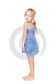 Shy pretty little girl in blue dress