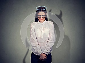 Shy quiet angel woman with devil character photo