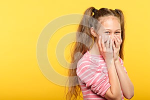 Shy smiling embarrassed girl covering mouth hands