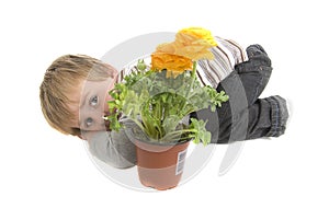 Shy toddler wiht potted flowers