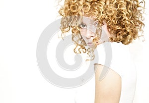 Shy young woman with curly hair