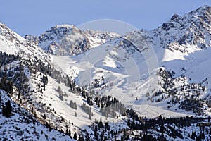 Shymbulak gorge and mountains with ski slopes. Winter mountains landscape.