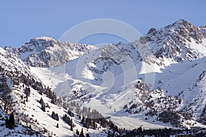 Shymbulak gorge and mountains with ski slopes. Winter mountains landscape.