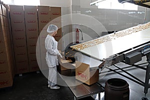Shymkent, Kazakhstan - 03.12.2020 : Rakhat confectionery factory. The finished cookies are rolled off the conveyor belt