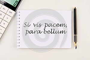 Si vis pacem, para bellum. Latin phrase meaning If you want peace, prepare for the war. on a white notebook