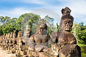 Image in Angkor Wat complex temple. Decorated bridge with warrios guardian and naga serpent.