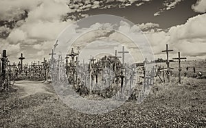 SIAULIAI, LITHUANIA - JULY 9, 2017: Tourists and pilgrims visit Hill of Crosses. The Hill Of Crosses in northern Lithuania has