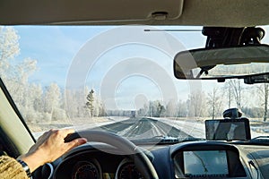 Siberia, Russia - November 28, 2020: View from of car interior from side of driver to the road and nature landscape