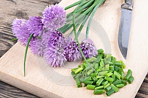 Siberian onion - Allium Schoenoprasum, cut on a plank. Vegetarian food and culinary use. Spices and