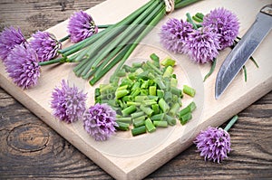 Siberian onion - Allium Schoenoprasum, cut on a plank. Vegetarian food and culinary use. Spices and