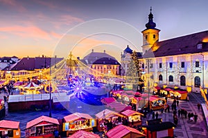 Sibiu, Romania. Christmas Market in Piata Mare at twilight.
