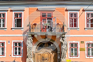 Sibiu, Romania - House with Caryatides - Beautiful house with identical statues and a balcony on a sunny summer day in Sibiu,