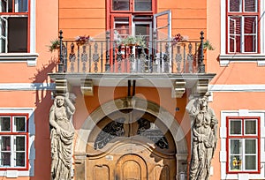 Sibiu, Romania - House with Caryatides - Beautiful house with identical statues and a balcony on a sunny summer day in Sibiu,