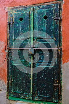 Sibiu, Romania, May 15, 2019: Traditional, colorful, decaying wooden courtyard doors of old townhouses in the center