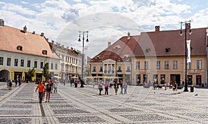 Sibiu, Romania - 2019. Tourist wondering in the panoramic The Big Square Piata Mare of Sibiu looking and the City hall