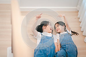 Sibling Asian girls having fun on the stairs