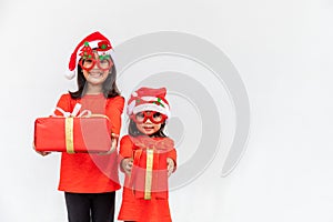 Sibling Asian girls in red Santa hat with gift boxes on white background