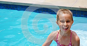 Sibling enjoying in swimming pool