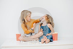 Sibling have fun feeding each other popcorn