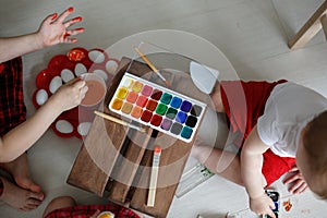 Sibling kids paint eggs , concept Easter