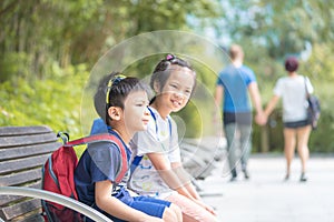 Sibling kids sitting in kowloon park