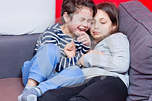 Sibling playing on bed