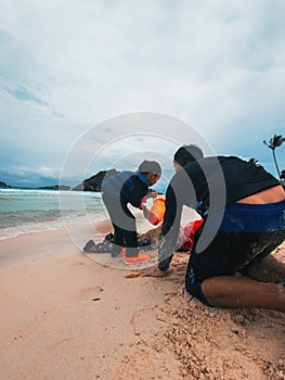 Sibling playing sand at the beach together