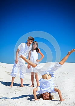 Sibling playing on white beach