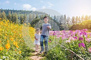 Sibling walking in flower park