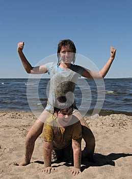 Siblings beach sandy fun