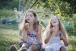 Siblings blowing soap bubbles