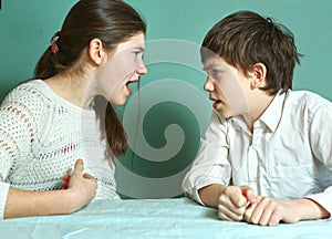 Siblings boy and girl arguin close up photo