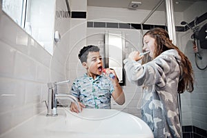 Siblings Brushing Their Teeth