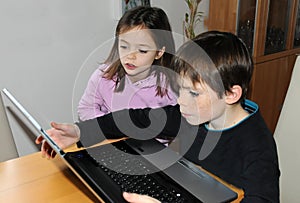 Siblings with computer