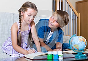 Siblings doing ordinary homework together