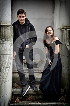 Siblings dressed in black in a spooky surrounding