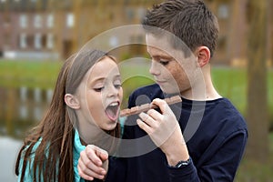 Siblings eating chocolate