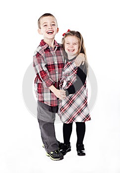 Siblings embracing in holiday clothes
