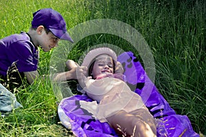 Siblings enjoying the sun, the brother teases his little sister